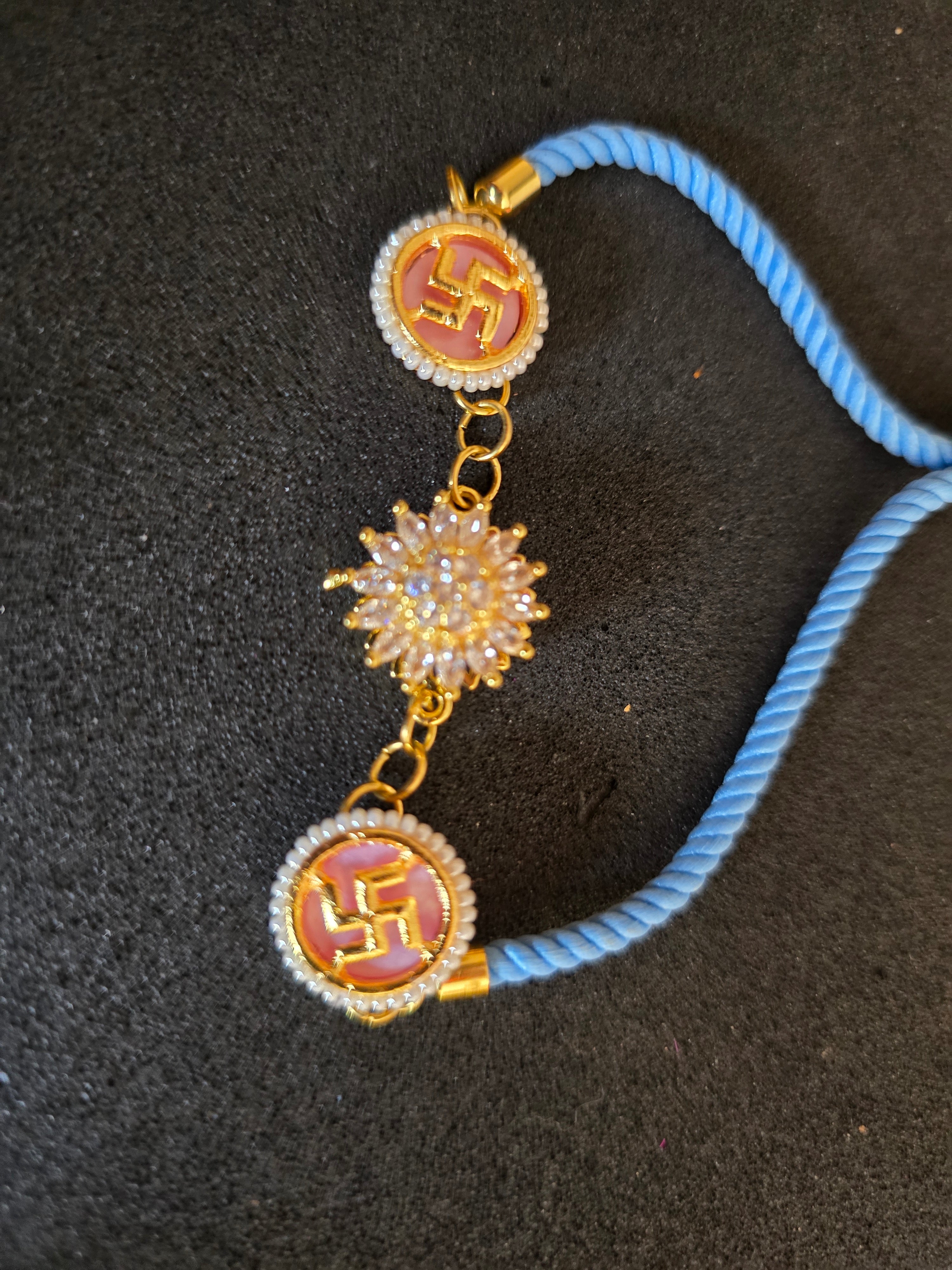 Swastika & Spining Floral Dial Rakhi