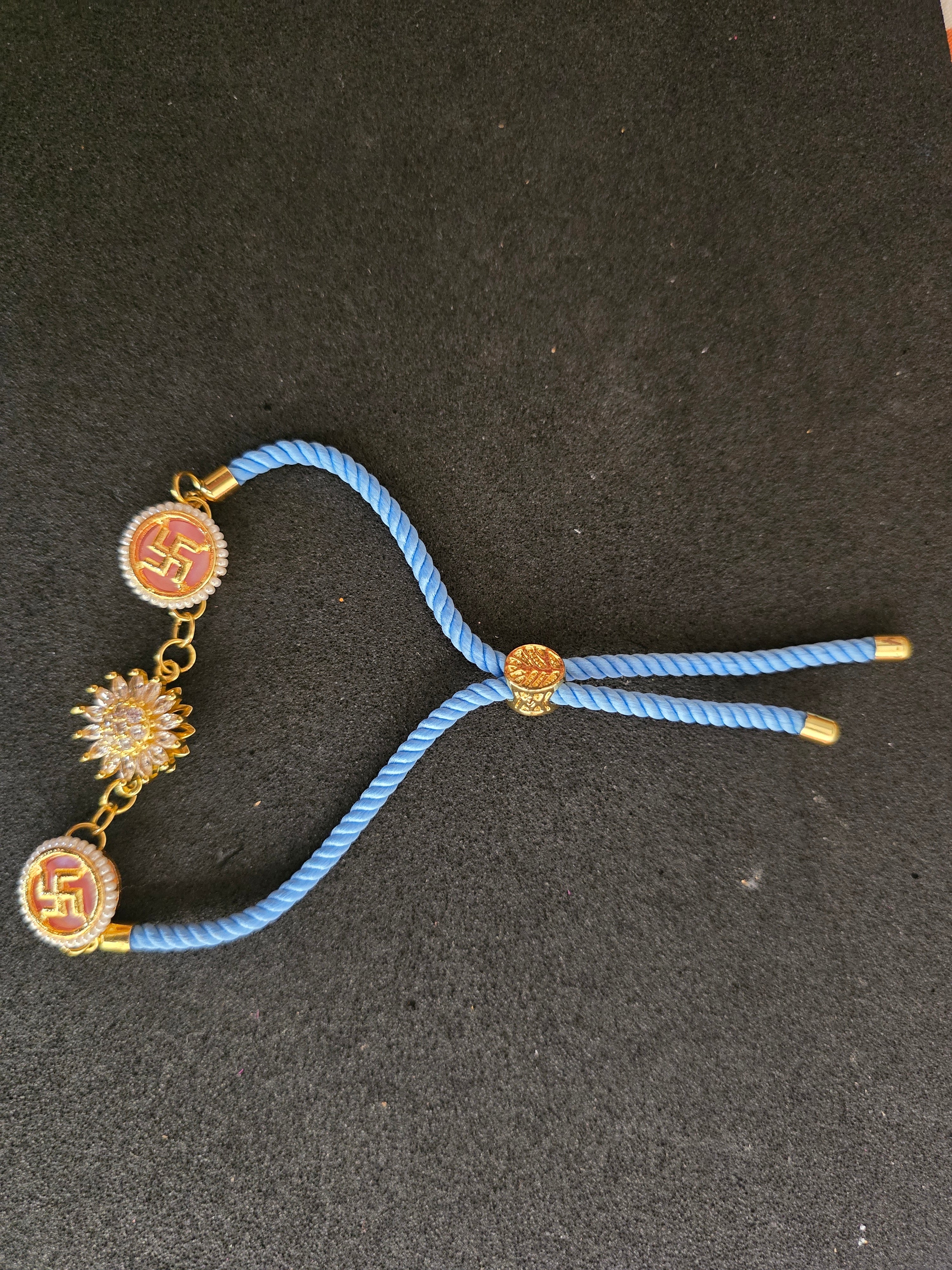 Swastika & Spining Floral Dial Rakhi